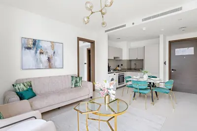 a living room with a couch and a table at New 2 bedroom in Meydan - Green Area in Dubai