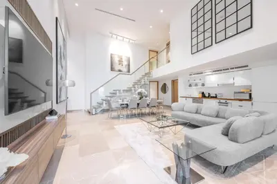 a living room with a couch and a table at Ultra Luxury JBR Duplex Penthouse - Free 5 star beach access in Dubai