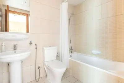 a bathroom with a toilet and a sink and a tub at Frank Porter - Lakeside Tower D in Dubai