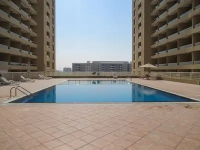 an empty swimming pool in the middle of a building at Frank Porter - Lakeside Tower D in Dubai