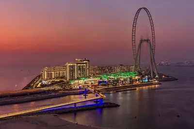 a view of a city with a ferris wheel at night at Ultra Luxe 5BR Al Bateen I Private Beach and Pool I JBR Full Sea View Beachfront in Dubai
