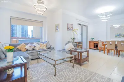 a living room with a couch and a table at JBR - Apartment plus maid in Dubai