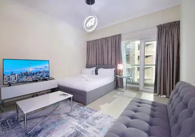 a hotel room with a bed and a couch at RH- Voguish, Studio in Downtown, short walk to Burj Khalifa in Dubai
