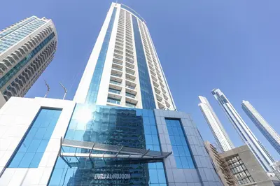a tall building with a blue sky in the background at RH- Voguish, Studio in Downtown, short walk to Burj Khalifa in Dubai