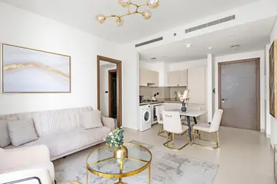 a living room with a couch and a table at Beautiful 2 bedroom next to Business Bay - Sobha Creek Vista in Dubai
