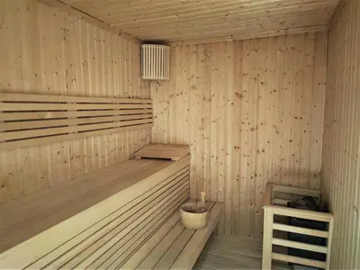 a wooden sauna with a bucket in it at Beautiful 2 bedroom next to Business Bay - Sobha Creek Vista in Dubai