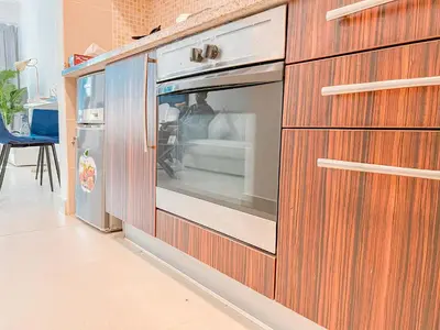 a wooden cabinet with a window in a room at Cosmos Living Elegant Studio Near Dubai Marina in Dubai