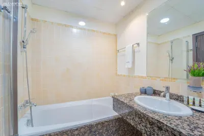 a bathroom with a tub and a sink at JBR - Shams Suites - Sea & Marina View Walking Distance to The Beach by Gardenia in Dubai
