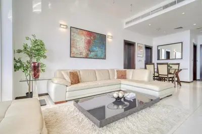 a living room with a couch and a table at Tiara Residences, Palm Jumeirah Dubai - Mint Stay in Dubai