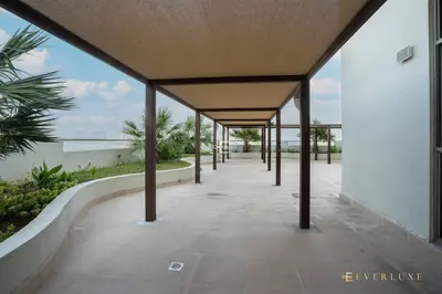 a covered walkway in a building with a view of the ocean at Everluxe Azizi Montrell Lovely Studio in Dubai