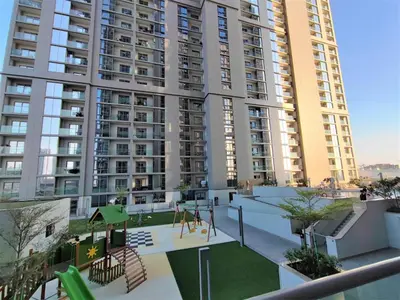 a playground in front of a large apartment building at Modern 1 bedroom - Close to Business Bay - Sobha Creek Vista in Dubai