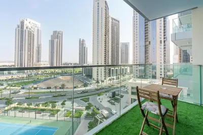 a balcony with a table and chairs and a view of a city at Lux BnB The Grand Creek Harbor Views in Dubai