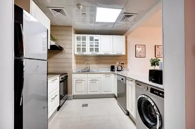 a kitchen with a refrigerator and a dishwasher at Big sea view studio in JBR in Dubai