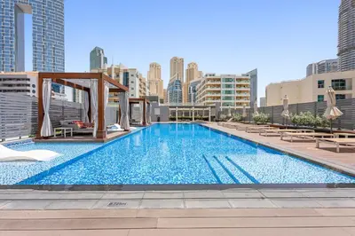 a large swimming pool on the roof of a building at ALiving Cozy Studio with Canal View I Studio One, Dubai Marina in Dubai