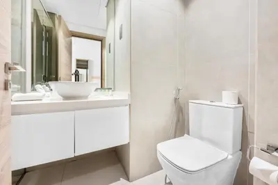 a bathroom with a white toilet and a sink at ALiving Cozy Studio with Canal View I Studio One, Dubai Marina in Dubai
