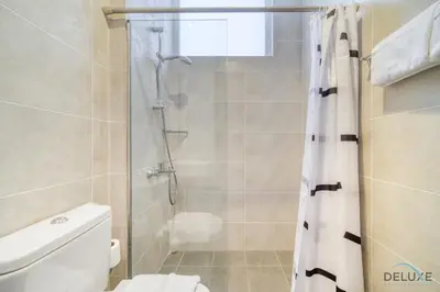 a bathroom with a shower and a toilet at Alluring 3BR Townhouse at DAMAC Hills 2, Dubailand by Deluxe Holiday Homes in Dubai