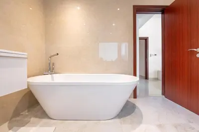 a large white bath tub in a bathroom at Deluxe Retreat In JBR - Million Dollar View - Balcony in Dubai