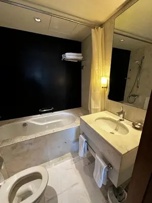 a bathroom with a tub and a toilet and a sink at Fashion Avenue Dubai Mall Highest Floor Burj Khalifa View Residence- Formerly Address Dubai Mall in Dubai
