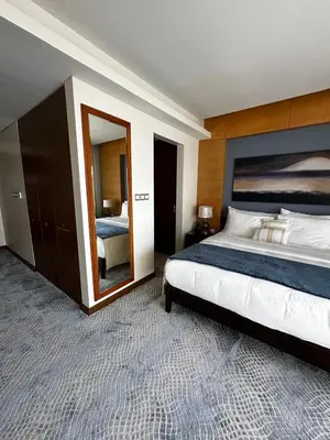 a bedroom with a large bed and a mirror at Fashion Avenue Dubai Mall Highest Floor Burj Khalifa View Residence- Formerly Address Dubai Mall in Dubai