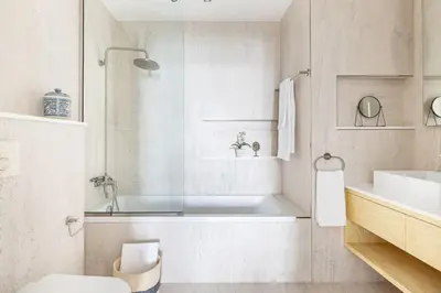a bathroom with a tub and a toilet and a sink at Frank Porter - Al Nabat in Dubai