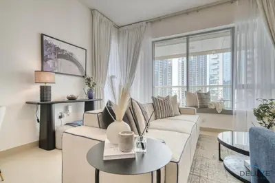a living room with a couch and a table at Harmonious 1BR at 29 BLVD Tower 1 Downtown Dubai by Deluxe Holiday Homes in Dubai