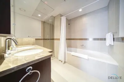 a bathroom with a sink and a tub and a shower at Harmonious 1BR at 29 BLVD Tower 1 Downtown Dubai by Deluxe Holiday Homes in Dubai