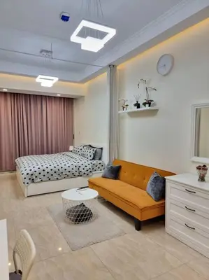 a living room with a couch and a bed at Premium Lovely Studio with Balcony in Dubai in Dubai