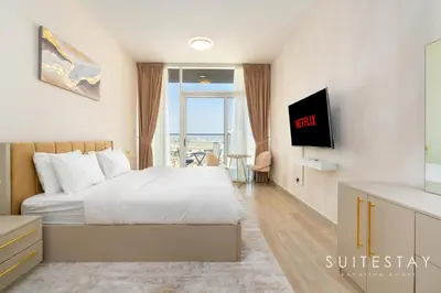 a hotel room with a bed and a tv at Prestigious Studio With High Quality Interiors in Dubai