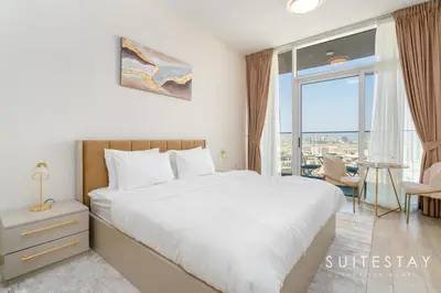 a bedroom with a bed and a large window at Prestigious Studio With High Quality Interiors in Dubai