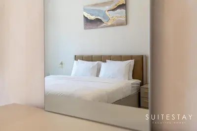 a mirror reflection of a bed in a bedroom at Prestigious Studio With High Quality Interiors in Dubai