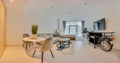 a living room with a couch and a table at Stylish studio in Marquise Square Tower in Dubai