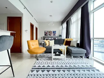 a living room with a couch and chairs at Trophy Stays - Vibrant Work-Friendly Studio in Business bay in Dubai