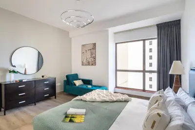 a living room with a couch and a mirror at The Smart Concierge - Amwaj 4 in Dubai