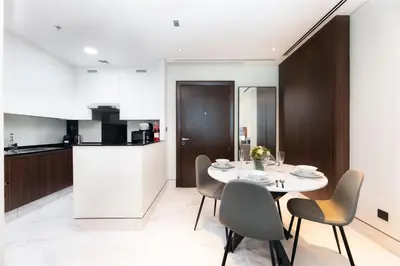 a kitchen and dining room with a table and chairs at SIMPLY COMFORT in J ONE Tower in Dubai