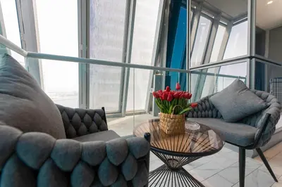 a living room with two couches and a table with flowers at SIMPLY COMFORT in J ONE Tower in Dubai