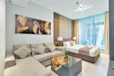 a living room with a couch and a bed at SIMPLY COMFORT in J ONE Tower in Dubai