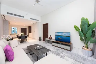 a living room with a couch and a tv at SIMPLY COMFORT in J ONE Tower in Dubai