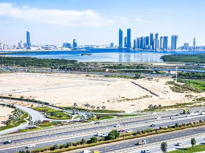 an aerial view of a highway with a city in the background at STAY BY LATINEM Luxury 2BR Holiday Home CV B1614 near Burj Khalifa in Dubai