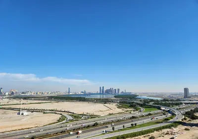 an aerial view of a highway with a city in the background at STAY BY LATINEM Luxury 2BR Holiday Home CV B1614 near Burj Khalifa in Dubai