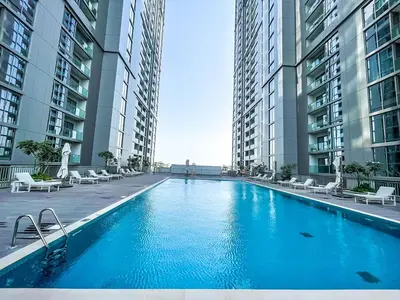 a large swimming pool in the middle of two tall buildings at STAY BY LATINEM Luxury 2BR Holiday Home CV B1614 near Burj Khalifa in Dubai