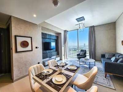 a living room with a dining table and a couch at STAY BY LATINEM Luxury 2BR Holiday Home CV B1614 near Burj Khalifa in Dubai