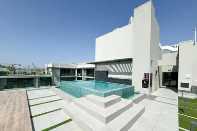 a swimming pool on the roof of a building at Mesmerizing nicely furnished studio in JVC in Dubai