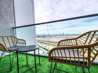 two chairs and a table on a balcony with a view at STAY BY LATINEM Luxury 1 BR Holiday Home OPA 1601 near Burj Khalifa in Dubai