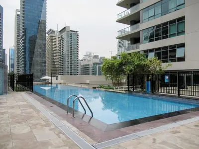 a swimming pool in a city with tall buildings at GuestReady - Oliver Twist in Dubai