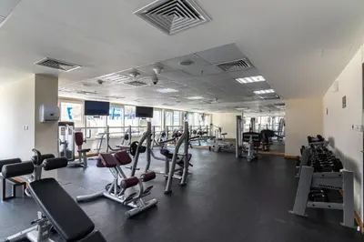 a gym with lots of treadmills and machines at GuestReady - Oliver Twist in Dubai