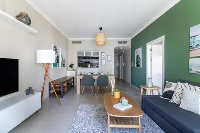 a living room with a couch and a table at GuestReady - Oliver Twist in Dubai
