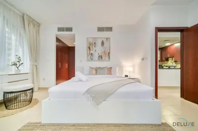 a white bedroom with a large white bed in it at Serene 1BR at Murjan 2 JBR by Deluxe Holiday Homes in Dubai