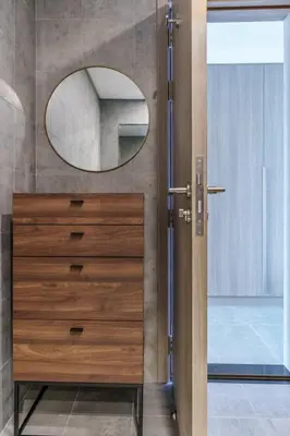a bathroom door with a mirror and a dresser at GuestReady - Modern Mirza with Marina View in Dubai