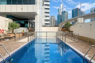 a swimming pool with blue water in a building at Frank Porter - Opal Tower in Dubai