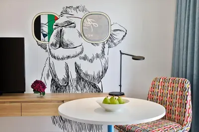 a room with a table with a cow wearing glasses at NH Collection Dubai The Palm in Dubai